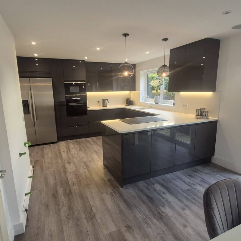 Dark handleless kitchen with island fitted by Interiors by KW, Lincolnshire
